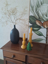 Load image into Gallery viewer, Beckah Evergreen Tree beeswax candle displayed on a wooden sideboard beside golden beeswax candles.