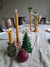 Load image into Gallery viewer, Green Evergreen Tree beeswax candle with a burgundy pomegranate candle on a Christmas table.
