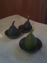Load image into Gallery viewer, Three fig-shaped candles on a textured surface with a wooden background
